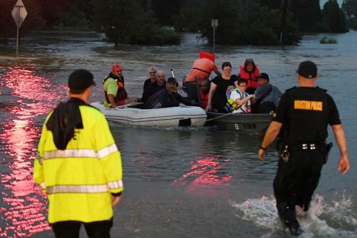 People are rescued from the Omni hotel by boat after Hurricane Harvey caused heavy flooding in Houston