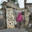 A girl walks through an area where a Nigerian fighter jet mistakenly bombed civilians in January