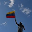 An opposition demonstrator holds a national flag during the "Towards Victory" protest against the government of Nicolas Maduro, in Caracas on June 10, 2017