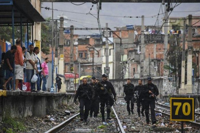 Rio police, shown here carrying out a pre-dawn crackdown on drug gangs in a favela, are demoralized and struggling to contain violence