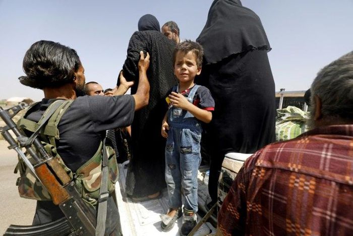 Displaced Syrians who fled from the Islamic State (IS) group's stronghold of Raqa arrive in the village of Hawi al-Hawa
