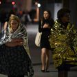 Members of the public, wrapped in emergency blankets, leave the scene of the terror attack on London Bridge in central London on June 3