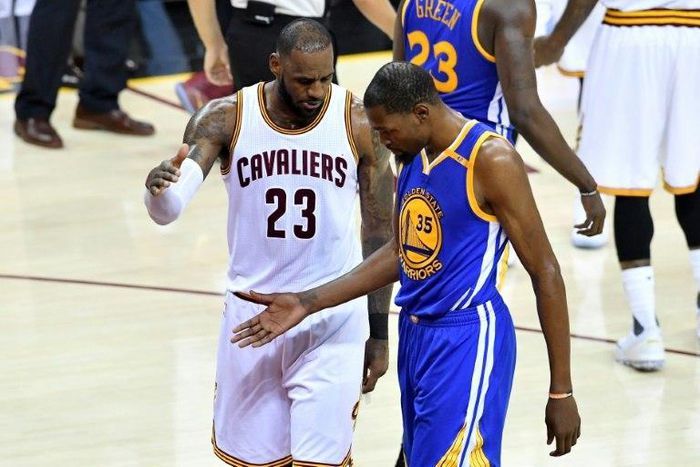 LeBron James of the Cleveland Cavaliers and Kevin Durant of the Golden State Warriors speak after a foul in the third quarter in Game 4 of the 2017 NBA Finals June 9, 2017