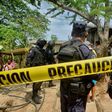 Police stand outside the house where were six people, including a four-month-old baby, were killed by gunmen in San Pedro Cacahuatepec, Acapulco municipality, Mexico's Guerrero state, on June 9, 2017