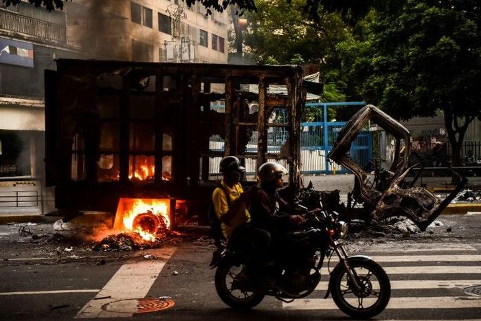 A truck burns during clashes between opposition activists and police in Caracas
