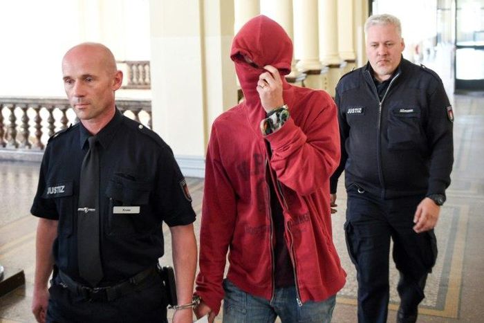 A 21-year-old Dutchman is escorted into court by officers for the first trial over violent riots against the G20 summit in Hamburg, northern Germany on August 28, 2017