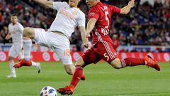 Connor Lade (R) of New York Red Bulls takes a shot as Jeff Larentowicz of Atlanta United defends in the first half during the Eastern Conference Finals Leg 2 match, at Red Bull Arena in Harrison, New Jersey, on November 29, 2018