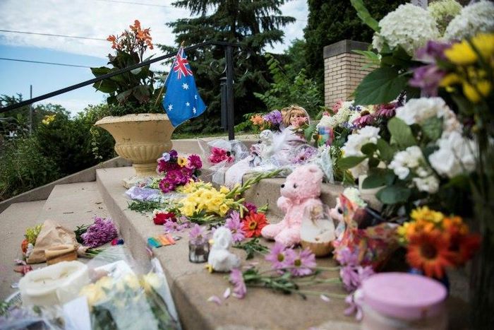 Flowers and signs memorialising Justine Damond are placed on the stairs of the Lake Harriet Spiritual Community centre in Minneapolis, Minnesota, on July 18, 2017