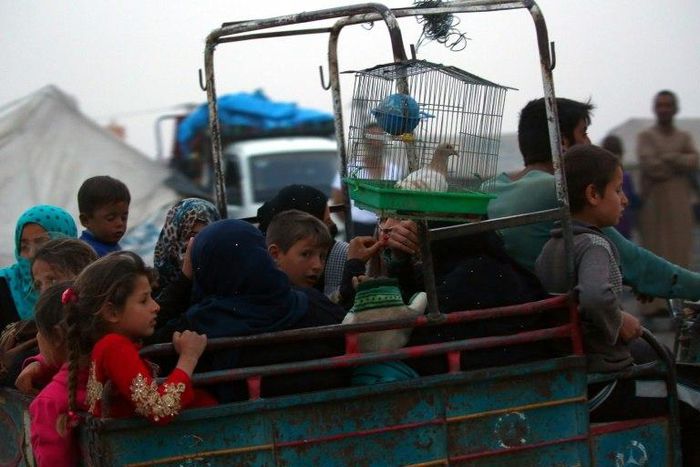 Displaced Syrians, who fled the countryside surrounding the Islamic State group stronghold of Raqa, arriving at a temporary camp in May 2017