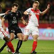 Caen's forward Ivan Santini (C) vies with Monaco's defender Djibril Sidibe (L) and defender Kamil Glik (R) during the French L1 football match December 21, 2016 at the Louis II Stadium in Monaco