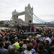 People gather for a vigil in Potters Fields Park, with Tower Bridge in the background, to commemorate the victims of the terror attack on London Bridge and at Borough Market