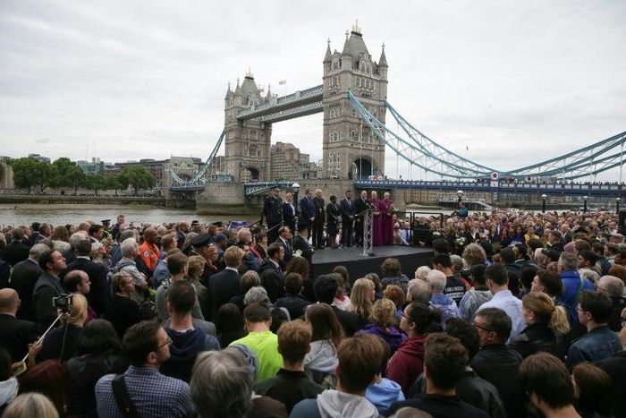 People gather for a vigil in Potters Fields Park, with Tower Bridge in the background, to commemorate the victims of the terror attack on London Bridge and at Borough Market