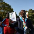 Anti-President Kabila protestors shout slogans and wave placards as they demonstrate near the entrance to a presidential guest house in Pretoria on June 24, 2017, where the President of the Democratic Republic of Congo Joseph Kabila and South African p...