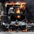 A truck set ablaze by opposition activists blocks an avenue during a protest in Caracas