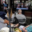 Patrons at Shaw's Tavern watch as former Federal Bureau of Investigation Director James Comey is sworn in to testify before the Senate Intelligence Committee on June 8, 2017