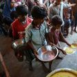 Indian villagers queue for food in the flood-hit village of Dagrua in Bihar
