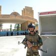 An Iraqi soldier stands guard outside the University of Mosul as students arrive to take their exams