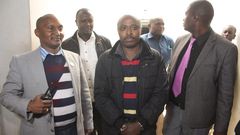Mugo wa Wairimu escorted by police officers during his court appearance