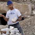 Archaeologist Yonatan Adler displays chalkstone mugs and cores on August 10, 2017, two months after they were discovered near the Israeli village of Reina, close to Cana