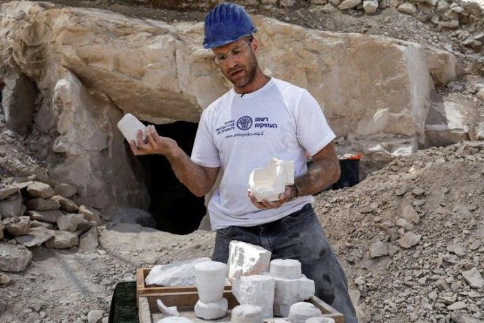 Archaeologist Yonatan Adler displays chalkstone mugs and cores on August 10, 2017, two months after they were discovered near the Israeli village of Reina, close to Cana
