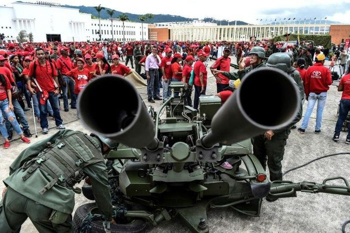 Members of Venezuela's army show civilians how to handle an anti-aircraft battery during military drills