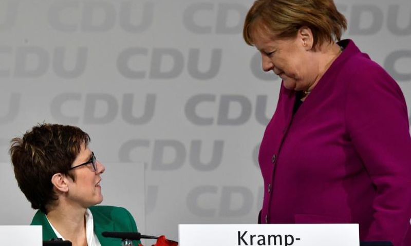 Merkel (R) got a political boost after her handpicked successor, Annegret Kramp-Karrenbauer (L), become newly-elected leader of her party