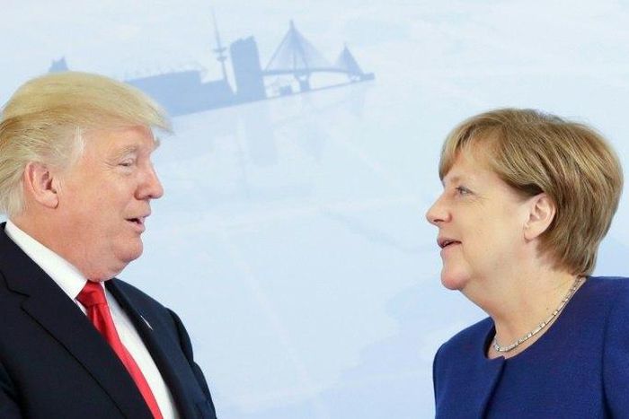 German Chancellor Angela Merkel (R) and US President Donald Trump pose for a photo prior to a bilateral meeting on the eve of the G20 summit in Hamburg, northern Germany, on July 6, 2017