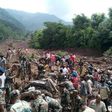 Rescuers look for survivors at the site of a landslide in Himachal Pradesh, northern India