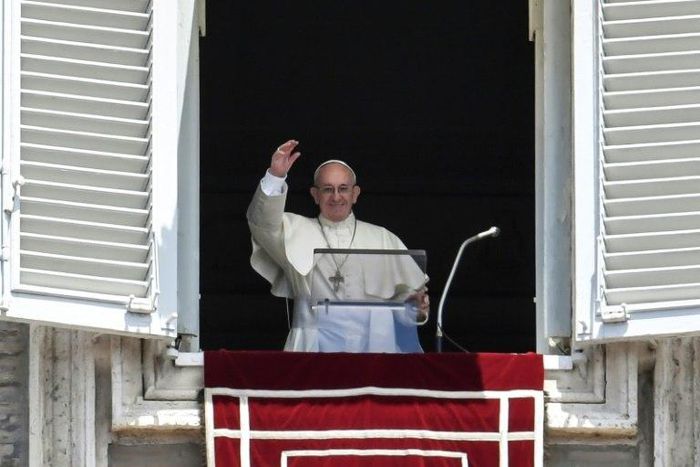 Pope Francis waves at the crowd during the Angelus prayer at the Vatican, on July 2, 2017