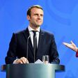 German Chancellor Angela Merkel gestures to French President Emmanuel Macron after addressing a press conference at the chancellery in Berlin on May 15, 2017
