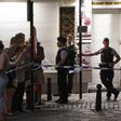 Police officials stand alert as members of the public gather behind a cordon on a street outside Gare Centrale in Brussels, on June 20, 2017