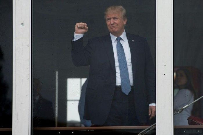 US President Donald Trump acknowledges spectators as he arrives at the 72nd US Women's Open Golf Championship at Trump National in Bedminister, New Jersey, July 14, 2017