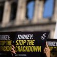 Amnesty International activists hold placards as they protest against the arrest of rights activists in Turkey, including Amnesty International's Turkey director, on July 20, 2017, near the Coliseum in Rome