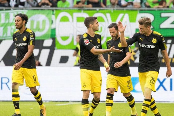 Dortmund's midfielder Christian Pulisic (2nd, L) celebrates scoring the opening goal with his teammates defender Lukasz Piszczek (R) and midfielder Gonzalo Castro (2nd R) during the Bundesliga football match against Wolfsburg August 19, 2017