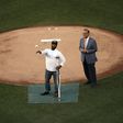 U.S. Capitol Hill special agent David Bailey (L), who was wounded in yesterday's shooting, throws out the first pitch at the Congressional Baseball Game in Washington, DC