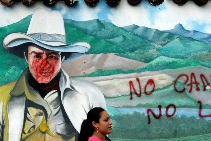 A woman is seen in front of a wall with a graffiti reading "No canal, no law" during a protest against the construction of an inter-oceanic canal in Juigalpa, Nicaragua on June 13, 2015