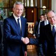 Italy's Minister of the Economy and Finance Pier Carlo Padoan (R) shakes hands with his French counterpart Bruno Le Maire in Rome on August 1, 2017