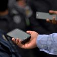 A Mexican journalist interviews a police officer during a protest rally in Chilpancingo, Guerrero state