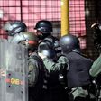 Venezuelan national guard officers in riot gear protect themselves during Friday's protest against President Nicolas Maduro's government