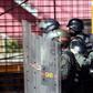 Venezuelan national guard officers in riot gear protect themselves during Friday's protest against President Nicolas Maduro's government