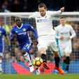 Swansea City's midfielder Gylfi Sigurdsson (C) runs forward with the ball during the English Premier League football match against Chelsea February 25, 2017