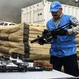 Handout picture released by the United Nations showing a member of the UN international observers' mission in Colombia holding a weapon surrendered by the Revolutionary Armed Forces of Colombia (FARC) as part of the peace process