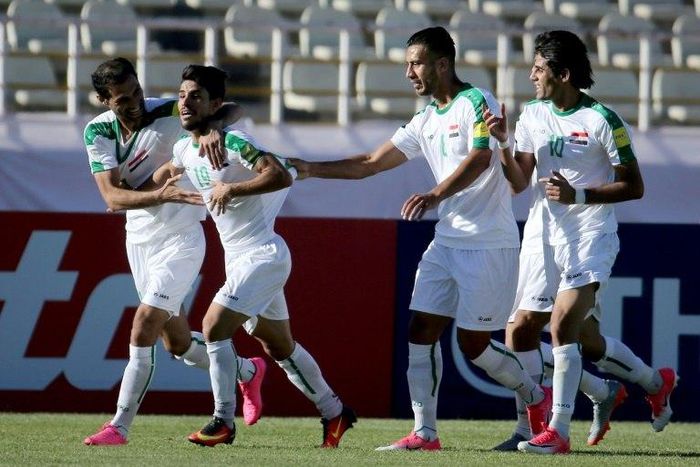 Iraqi players celebrate scoring against Japan during a 2018 World Cup qualifier in the Iranian capital Tehran on June 13, 2017