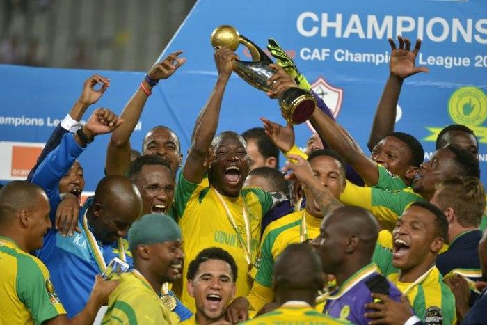 Mamelodi Sundowns players celebrate with the 2016 CAF Champions League trophy at the Borg el-Arab Stadium near Alexandria, Egypt on October 23, 2016