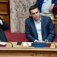 Greek prime minister Alexis Tsipras (R) and Greek foreign minister Nikos Kotzias look on during a debate on recent Cyprus talks on July 11, 2017 at the Greek parliament in Athens