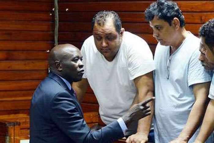 From left, lawyer Cliff Ombeta with suspects Baktash Akasha, Vijay Goswami, Gulam Hussein and Ibrahim Akasha at the Mombasa Law Courts