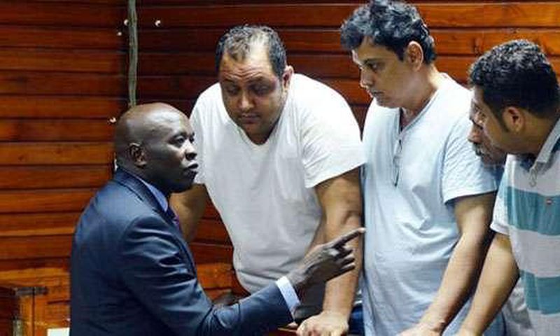From left, lawyer Cliff Ombeta with suspects Baktash Akasha, Vijay Goswami, Gulam Hussein and Ibrahim Akasha at the Mombasa Law Courts