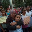 A Muslim woman hugs a child during a demonstration in Granada on August 23, 2017 in protest against a surge in anti-Islamic hate crimes following the deadly attacks in Barcelona and Cambrils