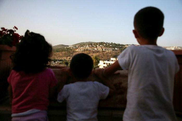Children from the Palestinian village of Deir Ibzi in the Israeli-occupied West Bank look at the Jewish settlement of Dolev on May 10, 2017