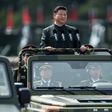 China's President Xi Jinping wore a Mao suit as he was driven in an open-top jeep past serried ranks of the People's Liberation Army, in a rare show of force in Hong Kong